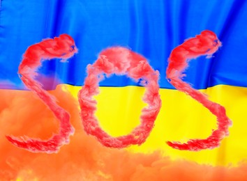 Image of Word SOS made of red smoke and national flag of Ukraine on background