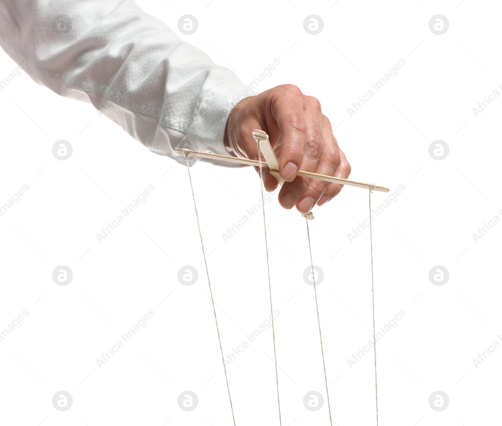 Photo of Man pulling strings of puppet on white background, closeup