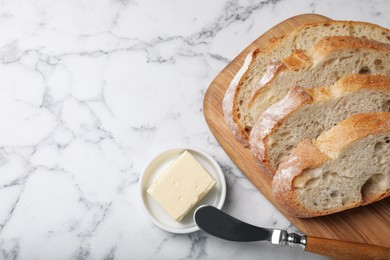 Photo of Freshly baked sodawater bread and butter on white marble table, flat lay. Space for text