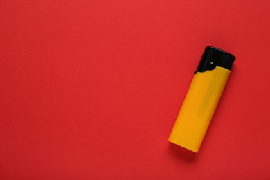 Photo of Stylish small pocket lighter on red background, top view. Space for text