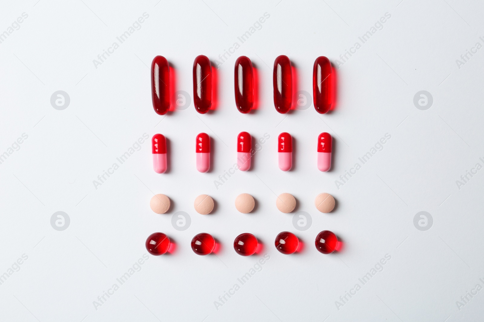 Photo of Many different pills on white background, top view