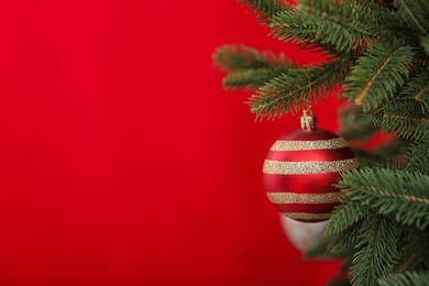 Beautifully decorated Christmas tree against color background, closeup