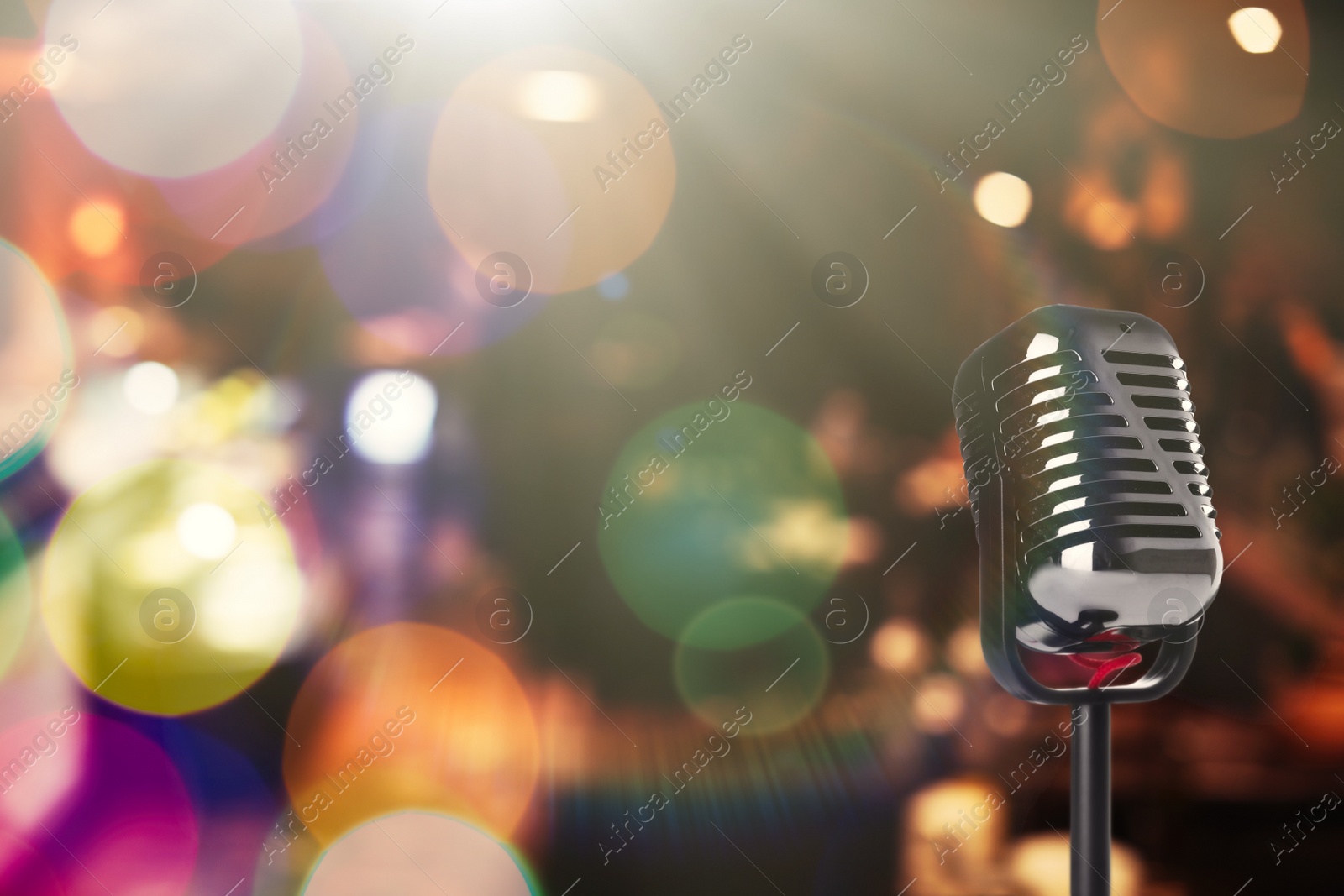 Image of Vintage microphone in karaoke club. Space for text