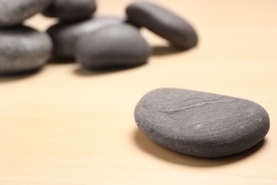 Spa stones on wooden background. Space for text