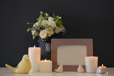 Beautiful burning candles, decor and flowers on table at home