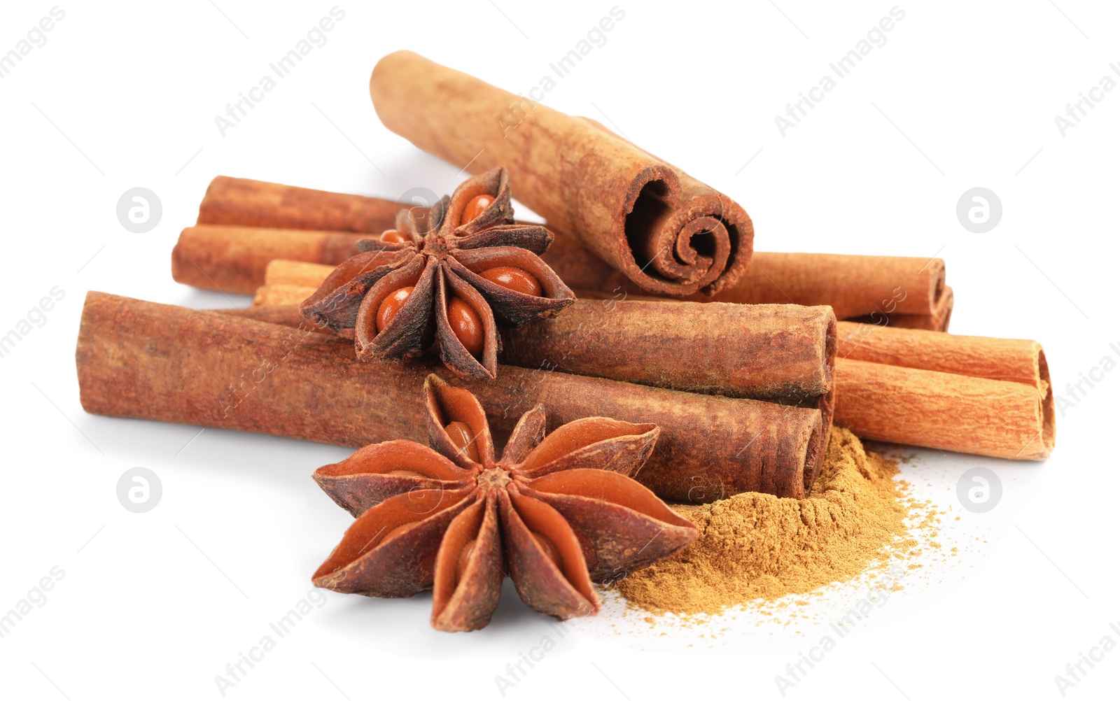 Photo of Dry aromatic cinnamon sticks, powder and anise stars isolated on white