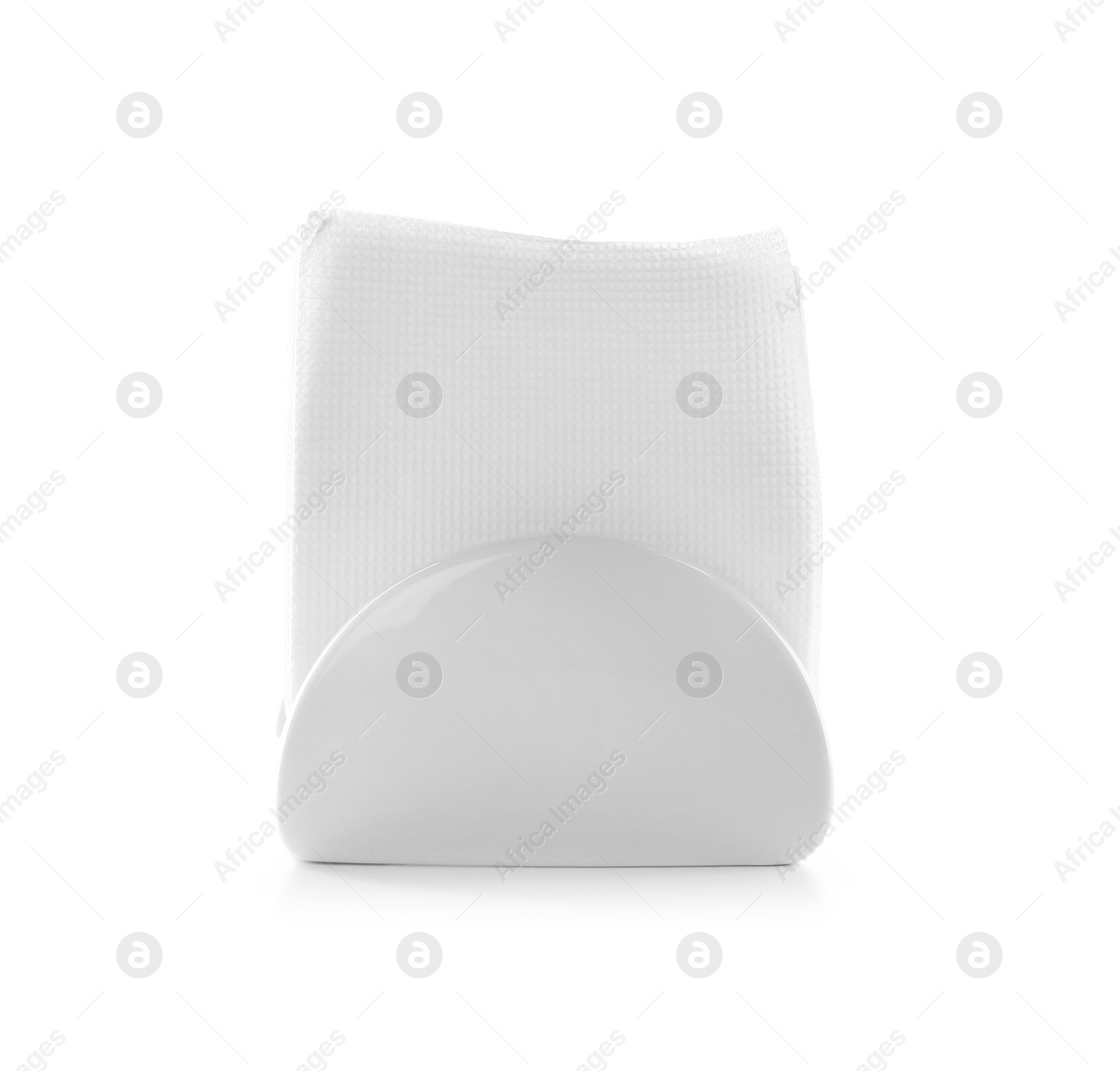 Photo of Napkin holder with paper serviettes on white background