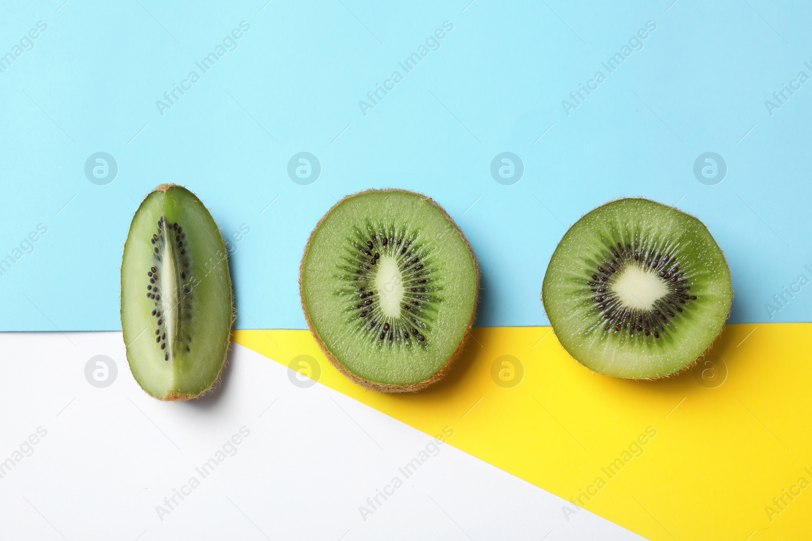 Photo of Top view of sliced fresh kiwi on color background