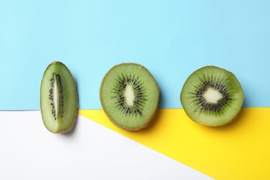 Top view of sliced fresh kiwi on color background