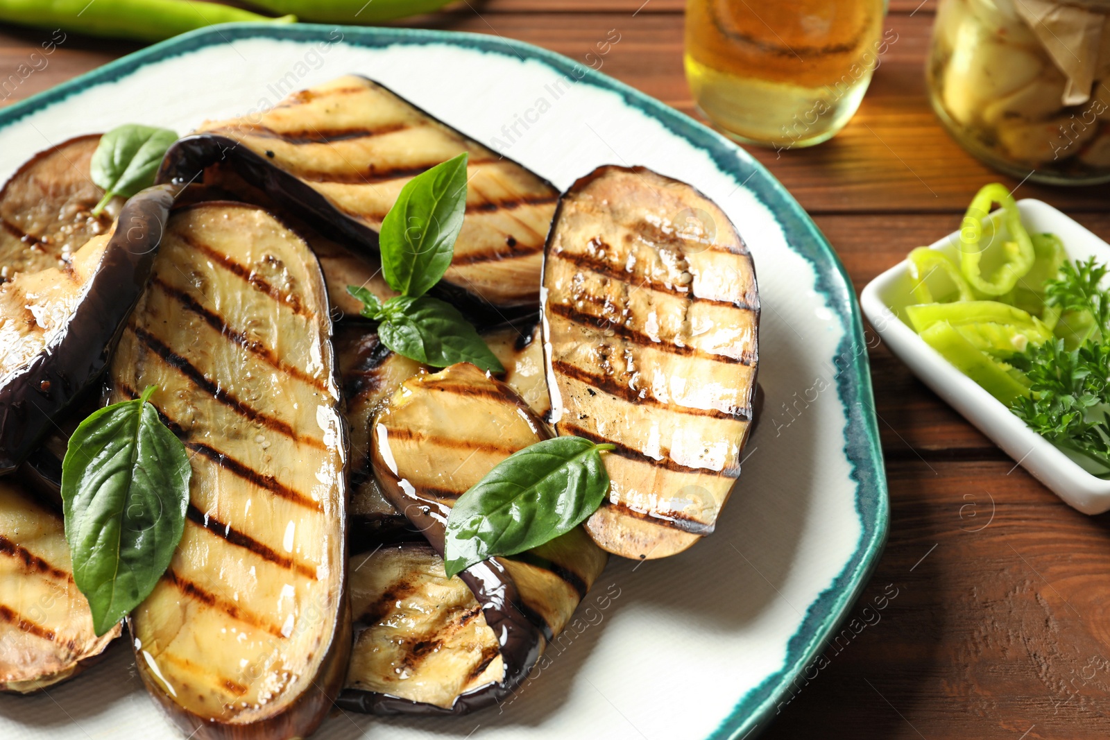 Photo of Plate with fried eggplant slices on table, closeup