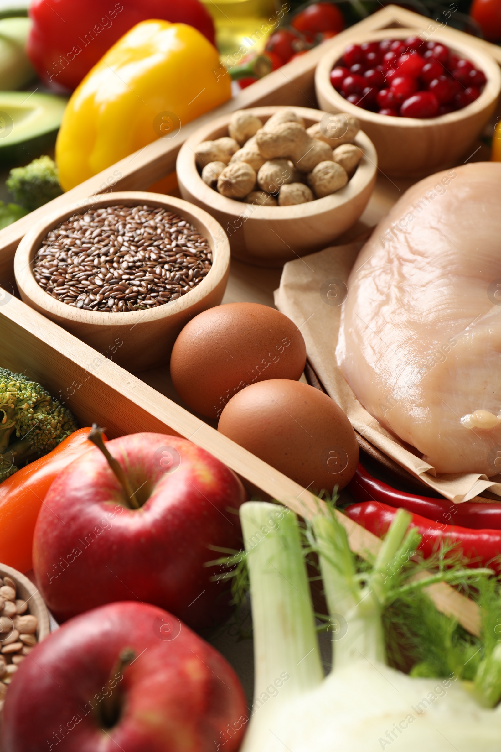 Photo of Raw chicken, seeds, nuts, berries and other healthy food, closeup