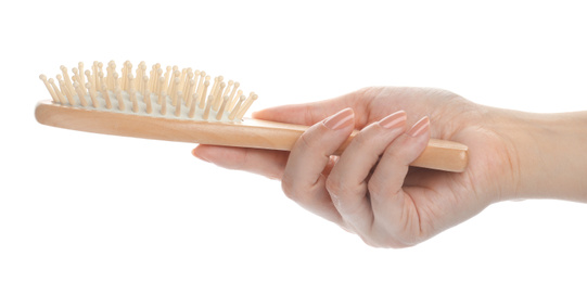 Photo of Woman holding wooden hair brush on white background, closeup