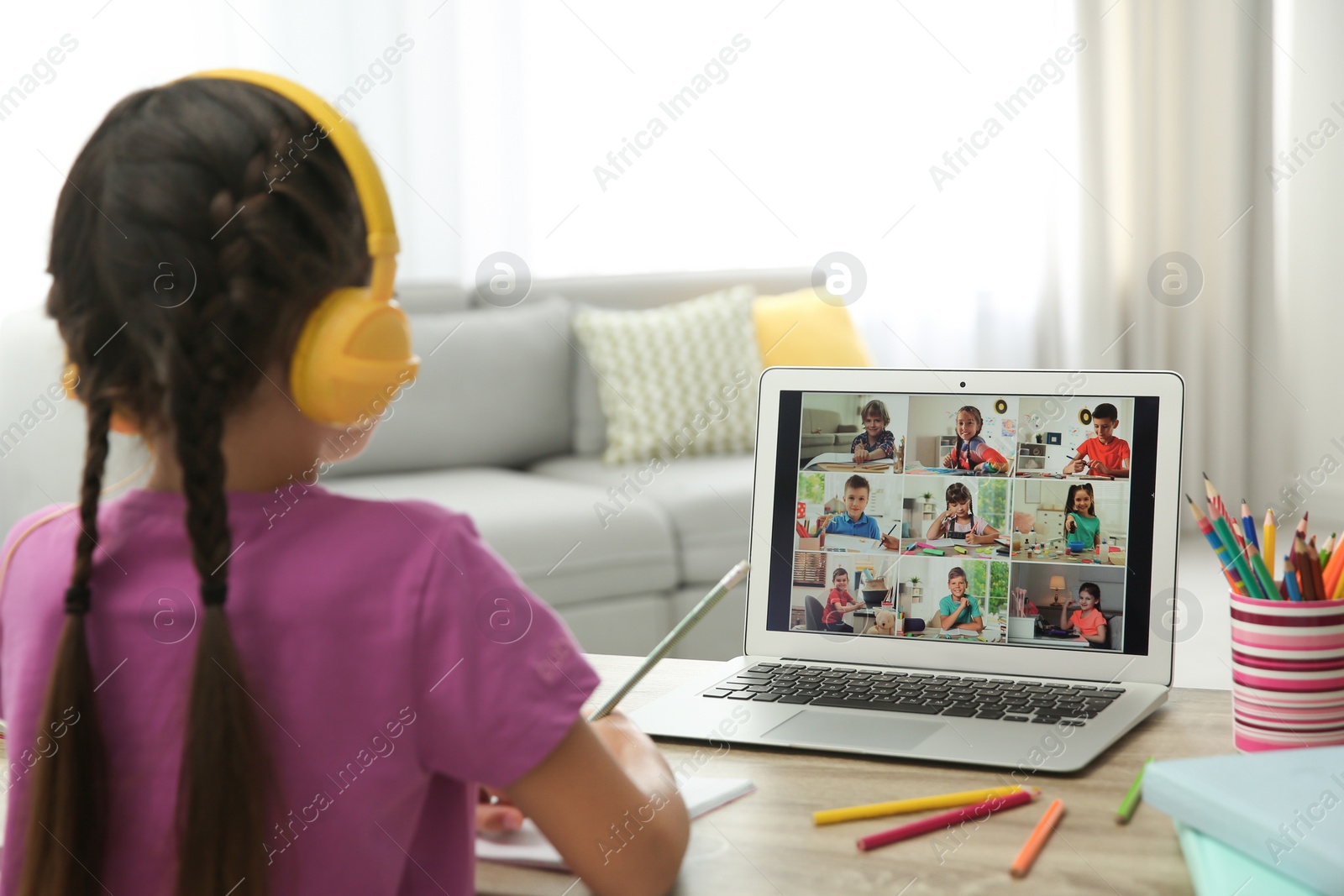 Photo of Distance learning during quarantine and lockdown due to Covid-19 pandemic. Girl having online school lesson with class indoors