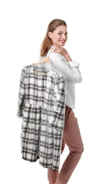 Young woman holding hanger with dress in plastic bag on white background. Dry-cleaning service