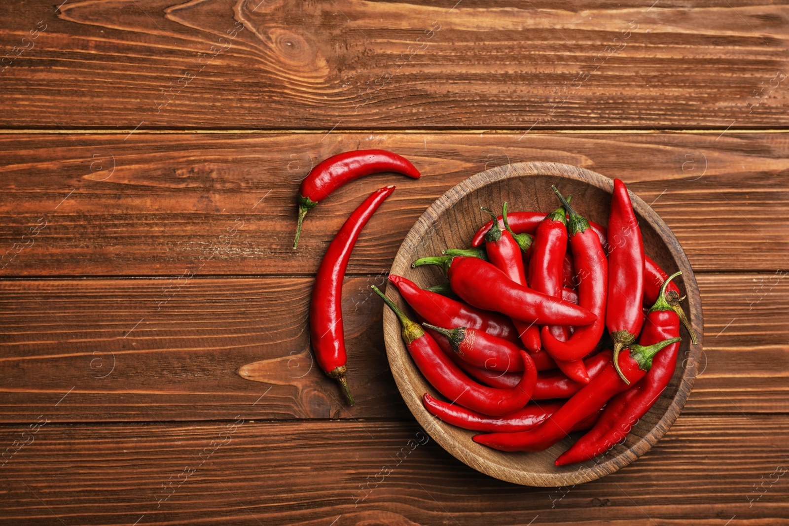 Photo of Flat lay composition with fresh chili peppers and space for text on wooden background