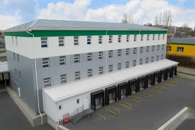 Image of Warehouse with loading docks outdoors, aerial view. Logistics center