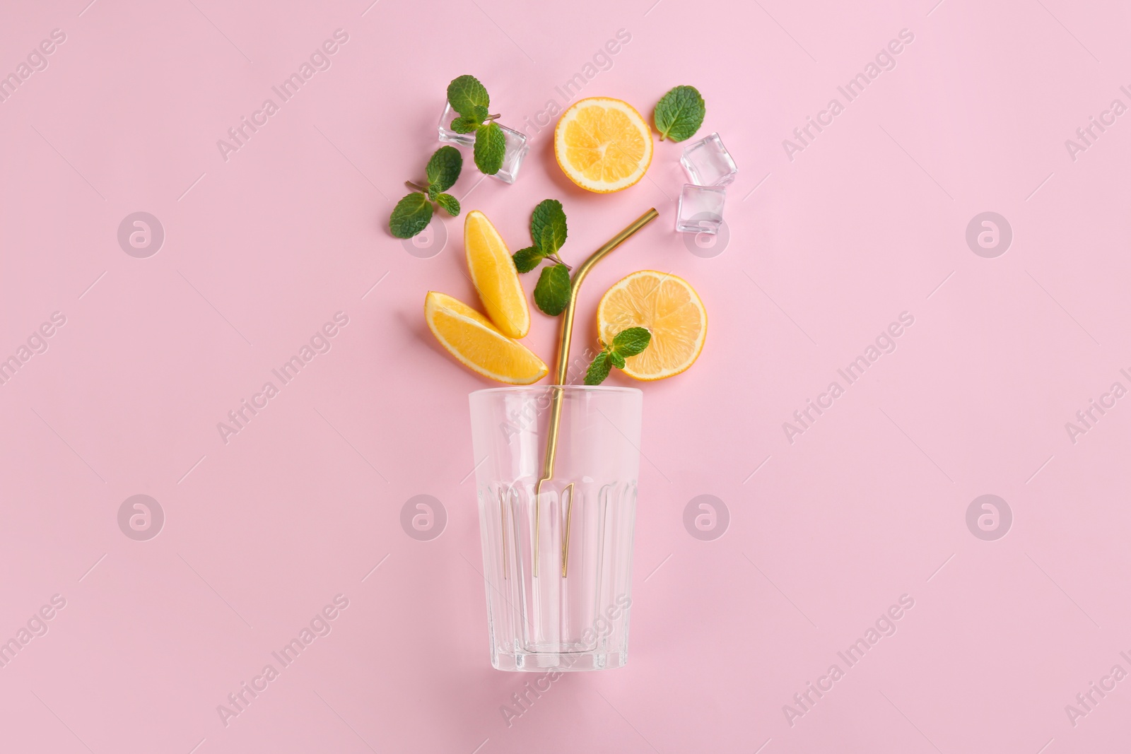 Photo of Creative lemonade layout with lemon slices, mint and ice on pink background, top view