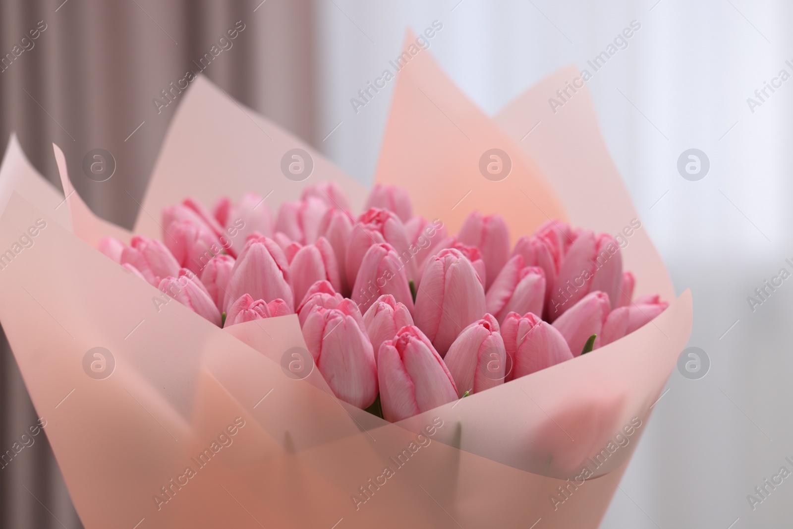 Photo of Bouquet of beautiful pink tulips on blurred background, closeup