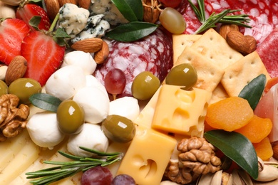 Different sorts of cheese, olives and other products, closeup