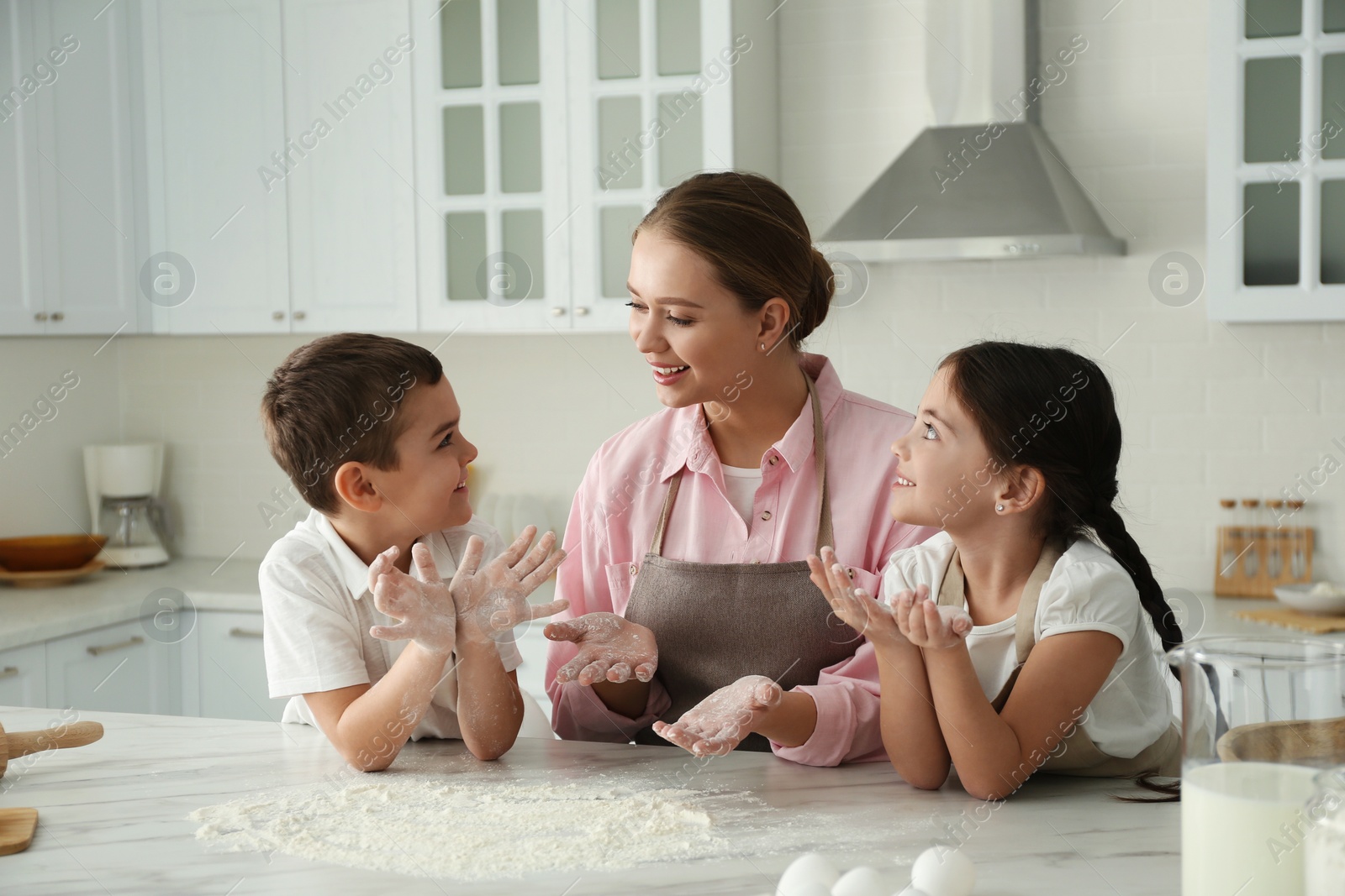 Photo of Happy family cooking together in kitchen at home