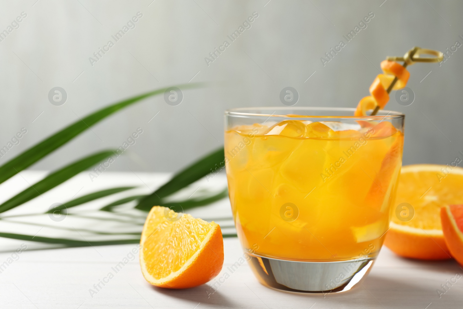 Photo of Delicious orange soda water on white table