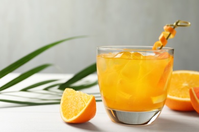 Photo of Delicious orange soda water on white table