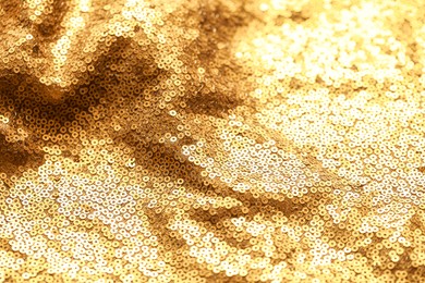 Photo of Beautiful golden shiny cloth with sequins as background, closeup