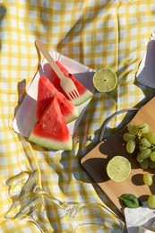 Photo of Delicious watermelon and fruits on picnic blanket, flat lay