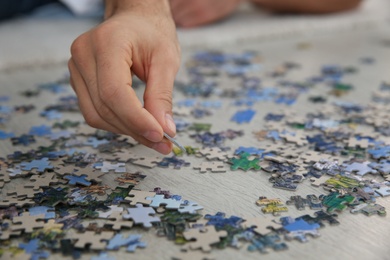 Man playing with puzzles on floor, closeup