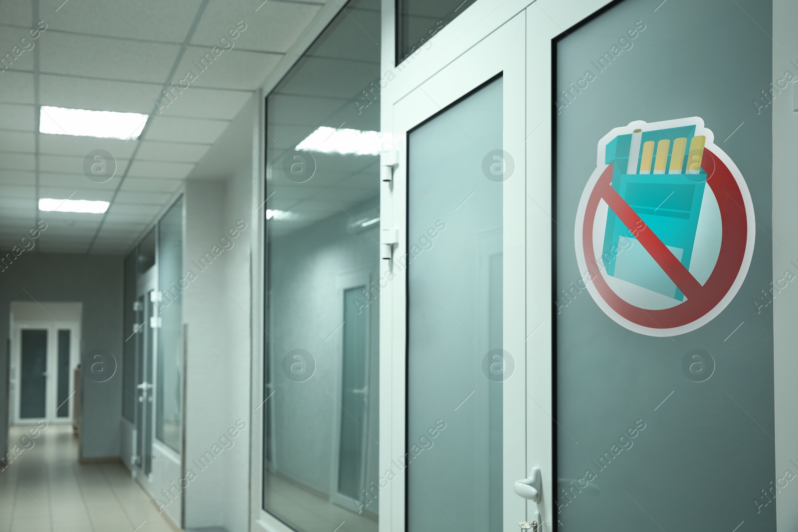 Image of Sign No Smoking drawn on glass door in clinic