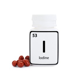 Photo of Plastic jar and iodine pills isolated on white