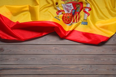 Photo of Flag of Spain on wooden background, top view. Space for text