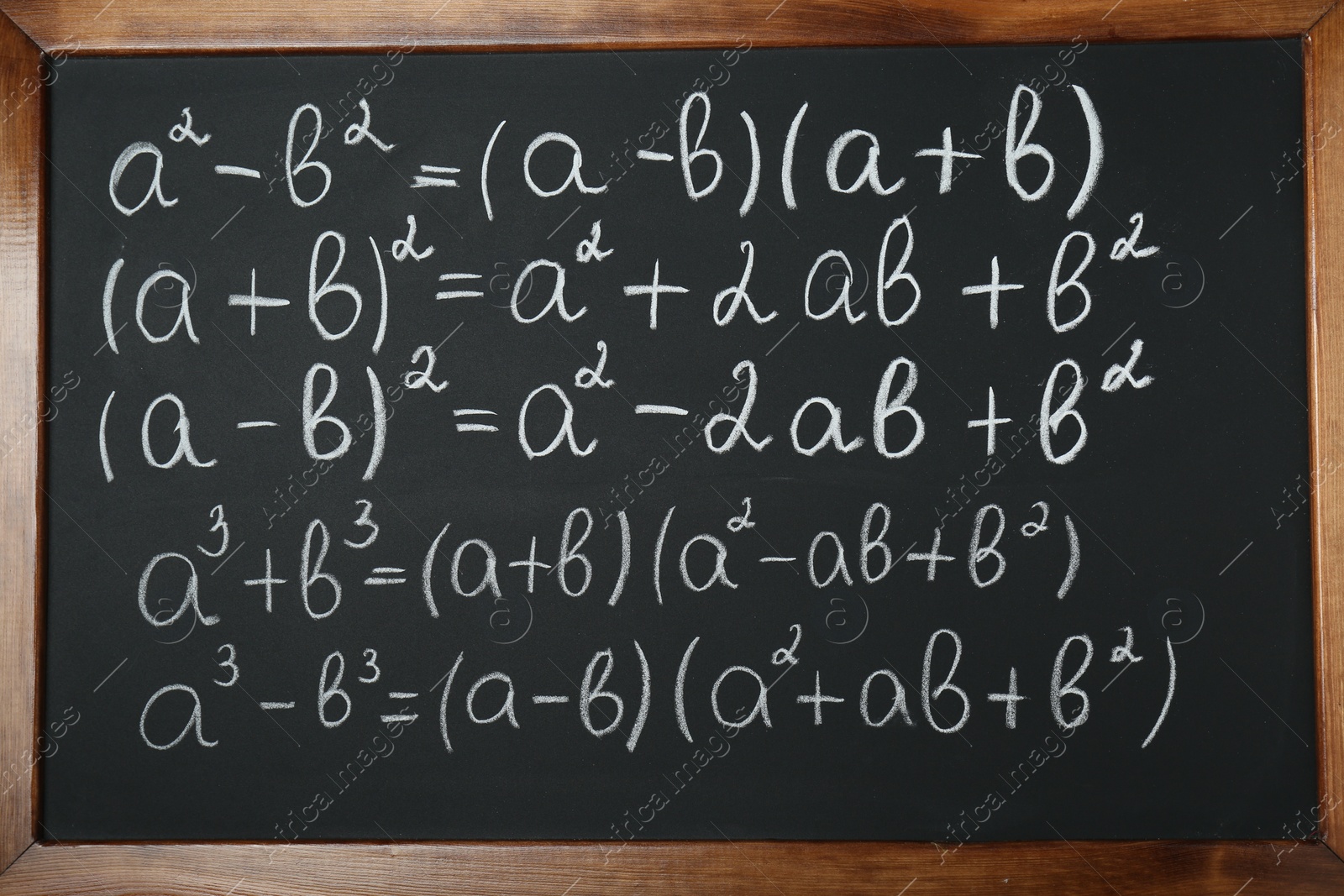 Photo of Many different math formulas written on chalkboard, closeup