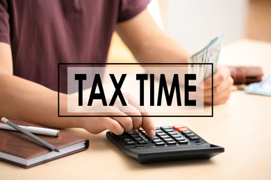 Image of Tax accountant working with calculator and money at table, closeup
