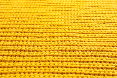 Photo of Yellow winter sweater as background, closeup view