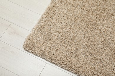 Photo of Beautiful beige carpet on floor, above view. Space for text