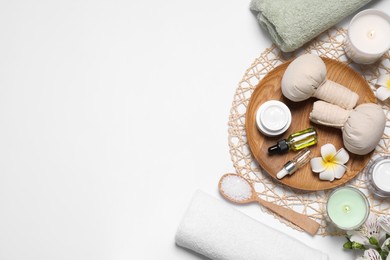 Flat lay composition with spa essentials on white background. Space for text