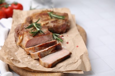 Photo of Delicious fried meat with rosemary on white table, closeup