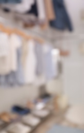 Photo of Blurred view of modern dressing room with stylish clothes