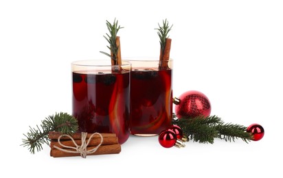 Aromatic Sangria drink in glasses and Christmas decor on white background