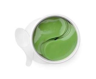 Photo of Jar of under eye patches with spoon isolated on white, top view. Cosmetic product