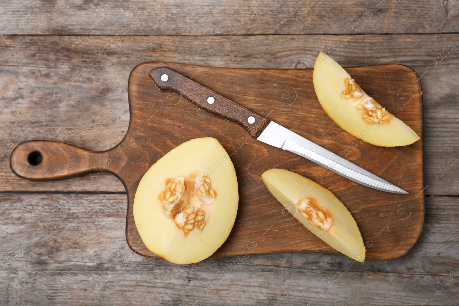 Photo of Flat lay composition with sliced ripe melon on wooden background