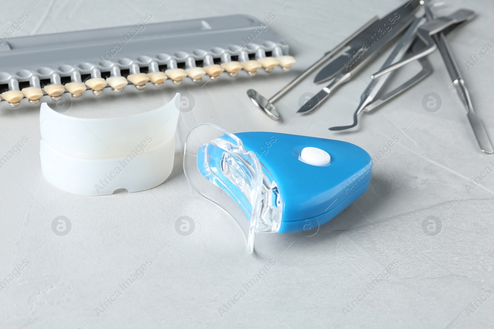 Photo of Composition with teeth whitener on grey table