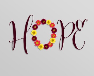 Word HOPE made with letters and beautiful flowers on light grey background, top view