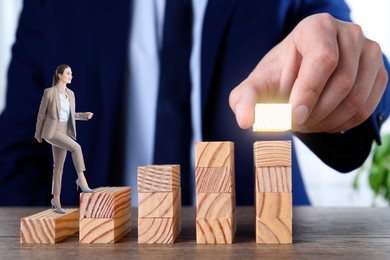 Image of Steps to success. Businesswoman climbing up stairs of wooden blocks. Man adding height to staircase, closeup