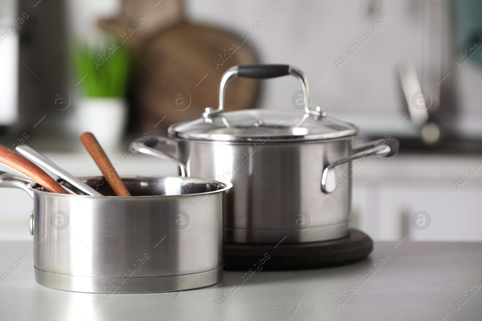 Photo of Cookware and kitchen utensils on grey table