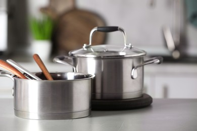 Photo of Cookware and kitchen utensils on grey table