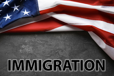 Image of American flag and word IMMIGRATION on grey background, top view