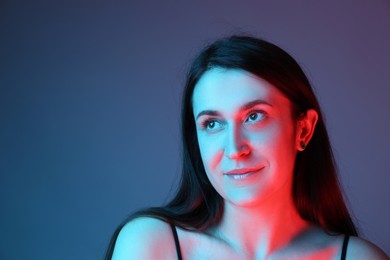 Portrait of beautiful young woman on color background