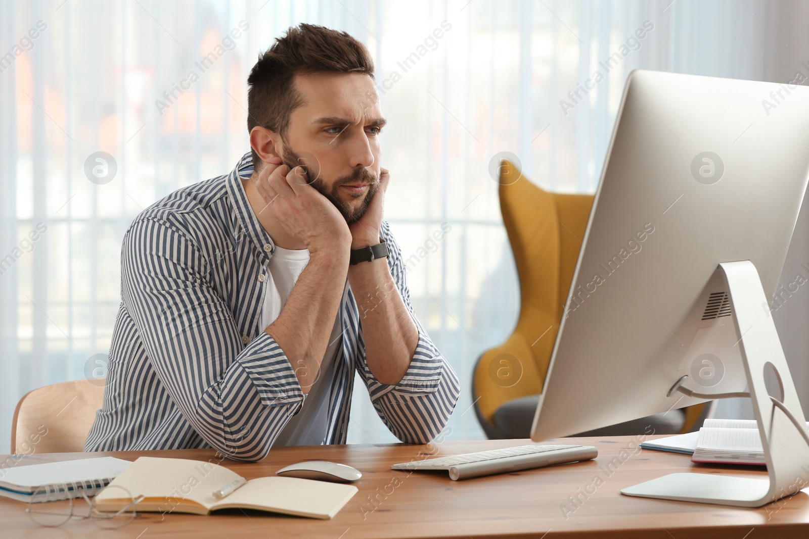 Photo of Online test. Man studying with computer at home